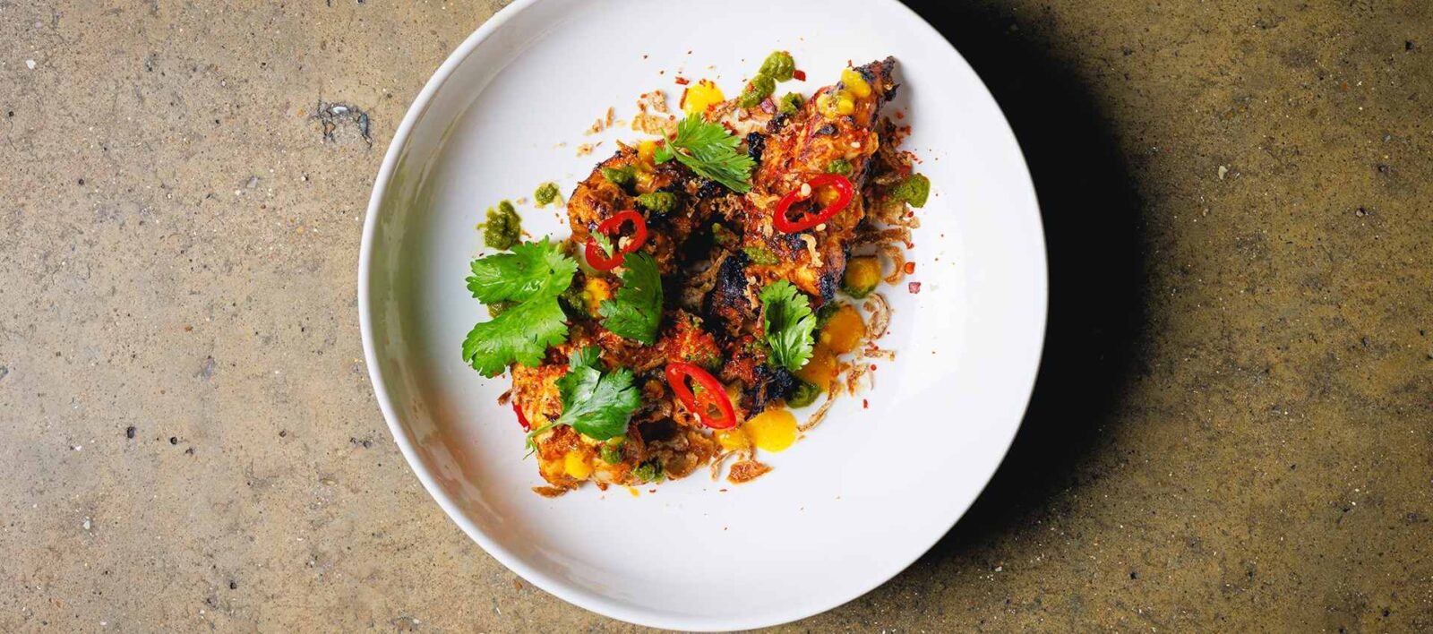 `Grilled chicken with amba and zhoug at Amber restaurant Aldgate East`
